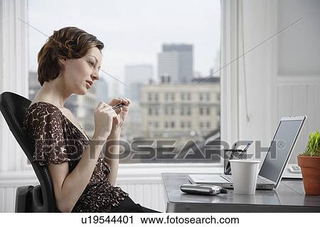 Woman with laptop thinking at desk View Large Photo Image Stock Image - Woman with laptop thinking at desk. Fotosearch