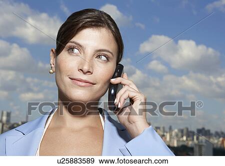 Businesswoman on cell phone, city in background, Sao Paulo, Brazil View Large Photo Image Stock Photo - Businesswoman on cell phone, city in background, Sao Paulo, Brazil. Fotosearch