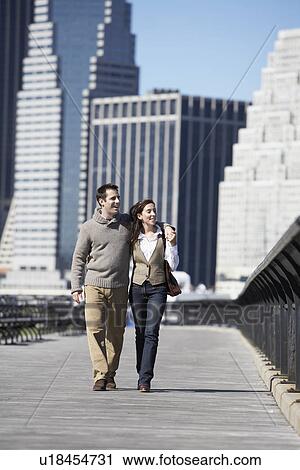 Couple walking on bridge, New York City, New York, USA View Large Photo Image Stock Image - Couple walking on bridge, New York City, New York, USA. Fotosearch