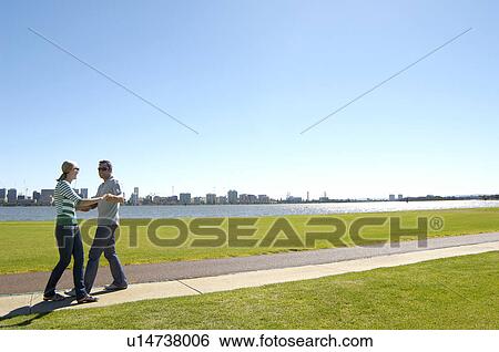 Mature couple dancing in park with city in background, Perth, Australia View Large Photo Image Stock Photograph - Mature couple dancing in park with city in background, Perth, Australia. Fotosearch