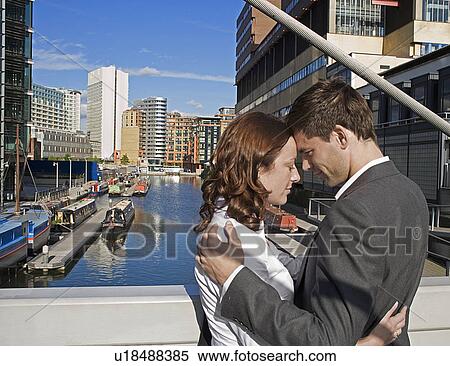 Mid Adult Couple Hugging at Bridge View Large Photo Image Stock Photography - Mid Adult Couple Hugging at Bridge. Fotosearch