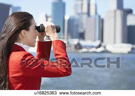 Woman using binoculars, New York City, New York, USA View Large Photo Image Stock Image - Woman using binoculars, New York City, New York, USA. Fotosearch