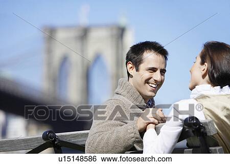 Young couple holding hands near Brooklyn Bridge, Brooklyn, New York City, New York, USA View Large Photo Image Stock Photograph - Young couple holding hands near Brooklyn Bridge, Brooklyn, New York City, New York, USA. Fotosearch