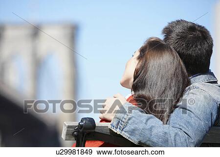 Young couple near Brooklyn Bridge (rear view), New York City, New York, USA View Large Photo Image Stock Photo - Young couple near Brooklyn Bridge (rear view), New York City, New York, USA. Fotosearch