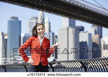 Young woman holding miniature Statue of Liberty, New York City, New York, USA View Large Photo Image Picture - Young woman holding miniature Statue of Liberty, New York City, New York, USA. Fotosearch