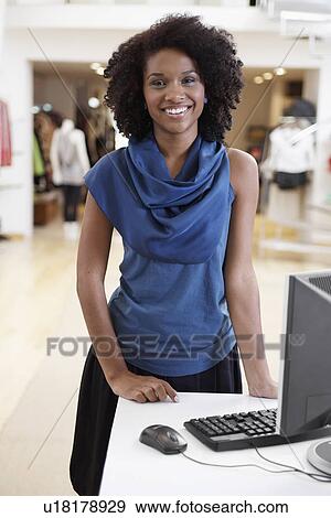Sales clerk in clothing store View Large Photo Image Stock Photo - Sales clerk in clothing store. Fotosearch