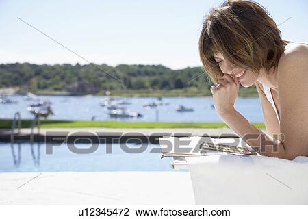 Woman reading and smiling View Large Photo Image Stock Image - Woman reading and smiling. Fotosearch