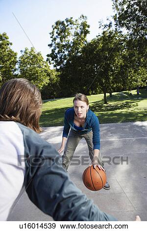 Young couple playing basketball View Large Photo Image Stock Photo - Young couple playing basketball. Fotosearch