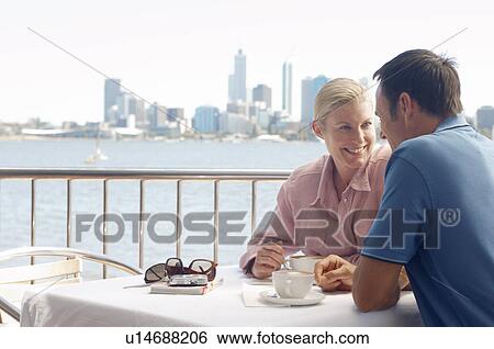 Mature couple drinking coffee in patio, city in background, Perth, Australia View Large Photo Image Stock Photograph - Mature couple drinking coffee in patio, city in background, Perth, Australia. Fotosearch