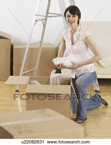 Young Woman Packing Cardboard Boxes View Large Photo Image Stock Image - Young Woman Packing Cardboard Boxes. Fotosearch