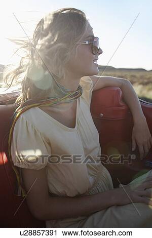 Young woman traveling in convertible View Large Photo Image Stock Image - Young woman traveling in convertible. Fotosearch
