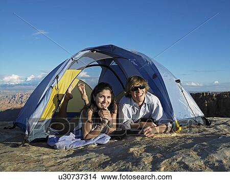 Picture - Mid Adult Couple Camping at Rock Strata. Fotosearch
