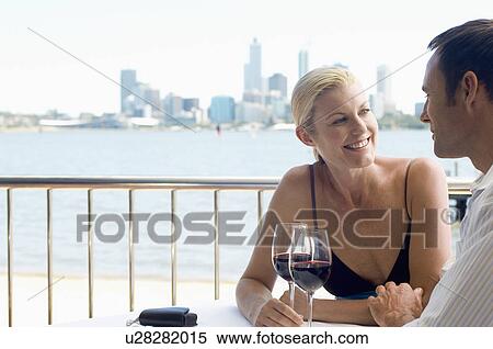 Mature couple drinking red wine, city in background View Large Photo Image Stock Photography - Mature couple drinking red wine, city in background. Fotosearch