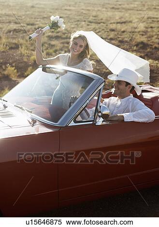 Newlyweds driving convertible through desert, Arizona, USA View Large Photo Image Stock Photography - Newlyweds driving convertible through desert, Arizona, USA. Fotosearch