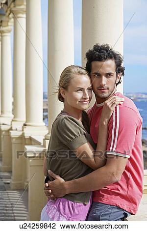 Young Couple Hugging on Balcony View Large Photo Image Stock Image - Young Couple Hugging on Balcony. Fotosearch