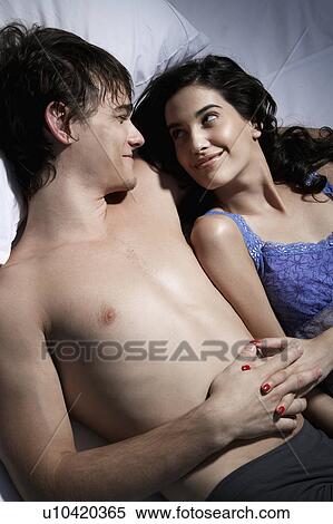 Young Couple Lying on Bed View Large Photo Image Stock Photography - Young Couple Lying on Bed. Fotosearch