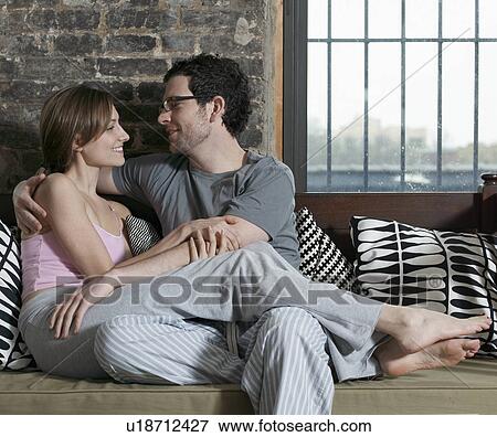Young Couple Relaxing on Sofa View Large Photo Image Stock Photo - Young Couple Relaxing on Sofa. Fotosearch