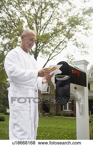 Stock Photo - Mature man going through mail, Chatham, New Jersey, USA. Fotosearch