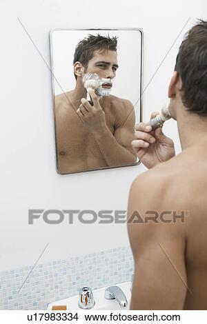 Picture - Mid adult man applying shaving cream. Fotosearch