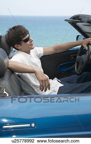 Stock Image - Mid-Adult Man Driving Convertible. Fotosearch