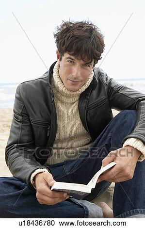 Stock Image - Mid-Adult Man Reading Book. Fotosearch
