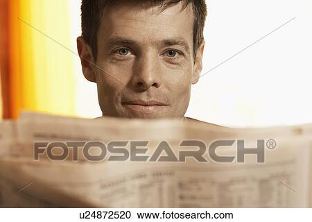 Mid adult man reading paper (portrait) View Large Photo Image Stock Image - Mid adult man reading paper (portrait). Fotosearch