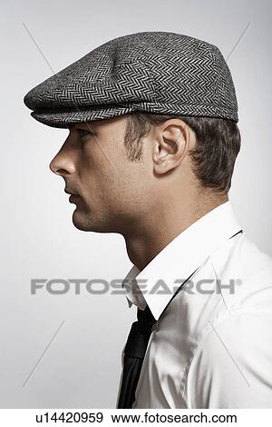 Profile of mid adult man wearing cap View Large Photo Image Stock Photo - Profile of mid adult man wearing cap. Fotosearch