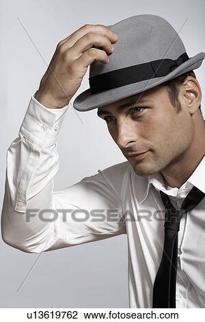 Mid adult man adjusting fedora View Large Photo Image Stock Image - Mid adult man adjusting fedora. Fotosearch