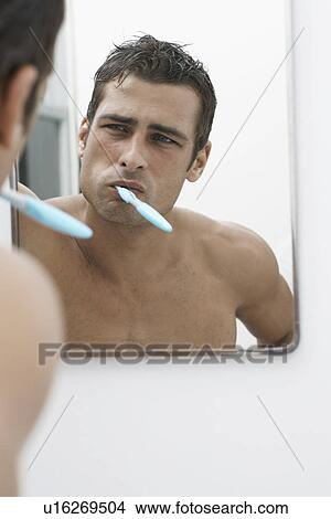 Mid adult man cleaning teeth View Large Photo Image Picture - Mid adult man cleaning teeth. Fotosearch