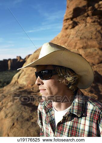 Stock Photography - Mid Adult Man in Cowboy Hat Looking View. Fotosearch