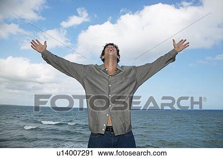 Mid-Adult Man Spreading Arms by Sea View Large Photo Image Stock Image - Mid-Adult Man Spreading Arms by Sea. Fotosearch