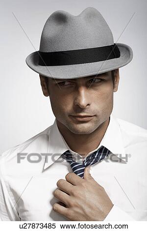 Mid adult man wearing fedora View Large Photo Image Stock Photography - Mid adult man wearing fedora. Fotosearch