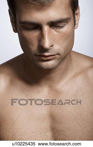 Stock Photography - Mid adult man with eyes closed. Fotosearch