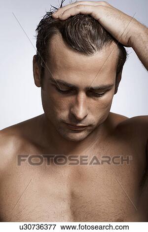 Mid adult man with hand in his hair View Large Photo Image Stock Photo - Mid adult man with hand in his hair. Fotosearch