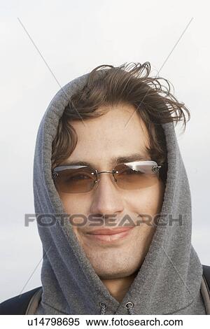 Stock Photography - Young man wearing hooded top (portrait). Fotosearch