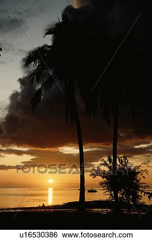Stock Photograph - Sun Setting Over Ocean. Fotosearch