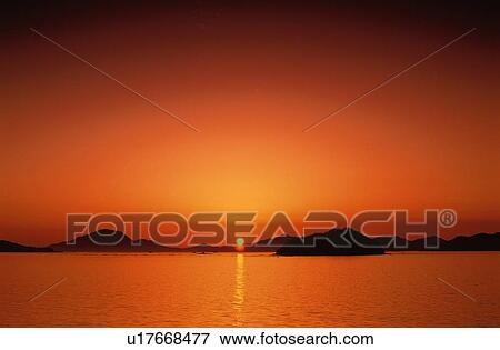 Stock Photo - Sunset Over Ocean. Fotosearch