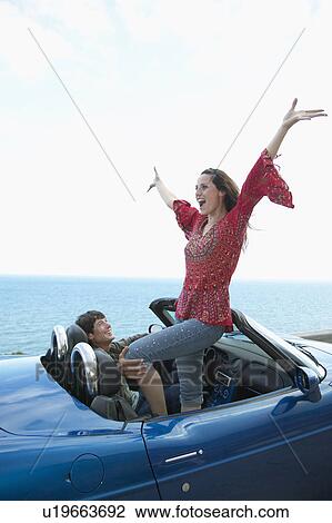 Carefree Mid-Adult Couple in Convertible View Large Photo Image Stock Image - Carefree Mid-Adult Couple in Convertible. Fotosearch