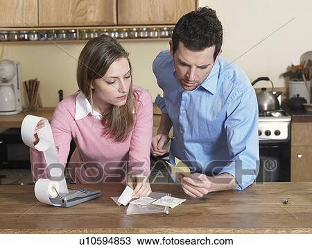 Mid-Adult Couple Examining Receipts View Large Photo Image Stock Image - Mid-Adult Couple Examining Receipts. Fotosearch
