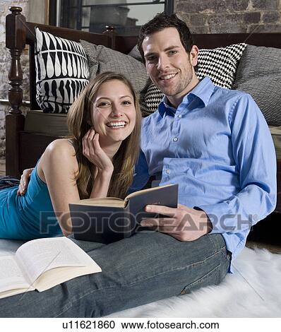 Mid-Adult Couple Reading on Floor View Large Photo Image Stock Image - Mid-Adult Couple Reading on Floor. Fotosearch