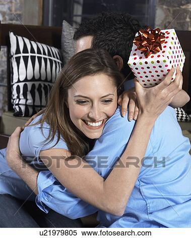Mid-Adult Woman with Present Hugging Boyfriend View Large Photo Image Stock Photography - Mid-Adult Woman with Present Hugging Boyfriend. Fotosearch