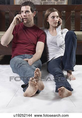 Couple Talking on Mobile Phones View Large Photo Image Picture - Couple Talking on Mobile Phones. Fotosearch
