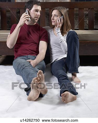 Stock Image - Couple Talking on Mobile Phones. Fotosearch
