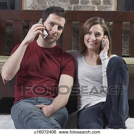 Couple Talking on Mobile Phones View Large Photo Image Stock Photograph - Couple Talking on Mobile Phones. Fotosearch