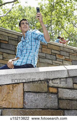 Teenage boy photographing himself with camera phone View Large Photo Image Stock Image - Teenage boy photographing himself with camera phone. Fotosearch