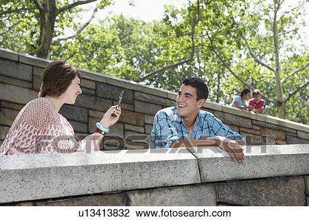 Teenage girl using camera phone on friend View Large Photo Image Stock Image - Teenage girl using camera phone on friend. Fotosearch