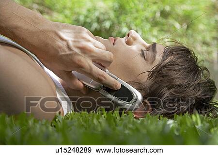 Young Man on Phone on Lawn View Large Photo Image Stock Photo - Young Man on Phone on Lawn. Fotosearch