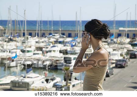 Young Woman on Mobile Phone at Harbor View Large Photo Image Stock Photograph - Young Woman on Mobile Phone at Harbor. Fotosearch