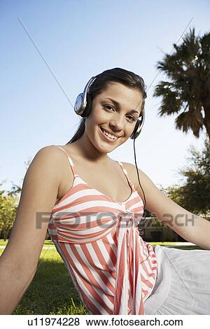Teenage girl listening to headphones (portrait) View Large Photo Image Stock Photo - Teenage girl listening to headphones (portrait). Fotosearch