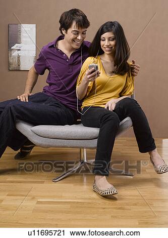 Young Couple Listening to MP3 Player View Large Photo Image Stock Image - Young Couple Listening to MP3 Player. Fotosearch
